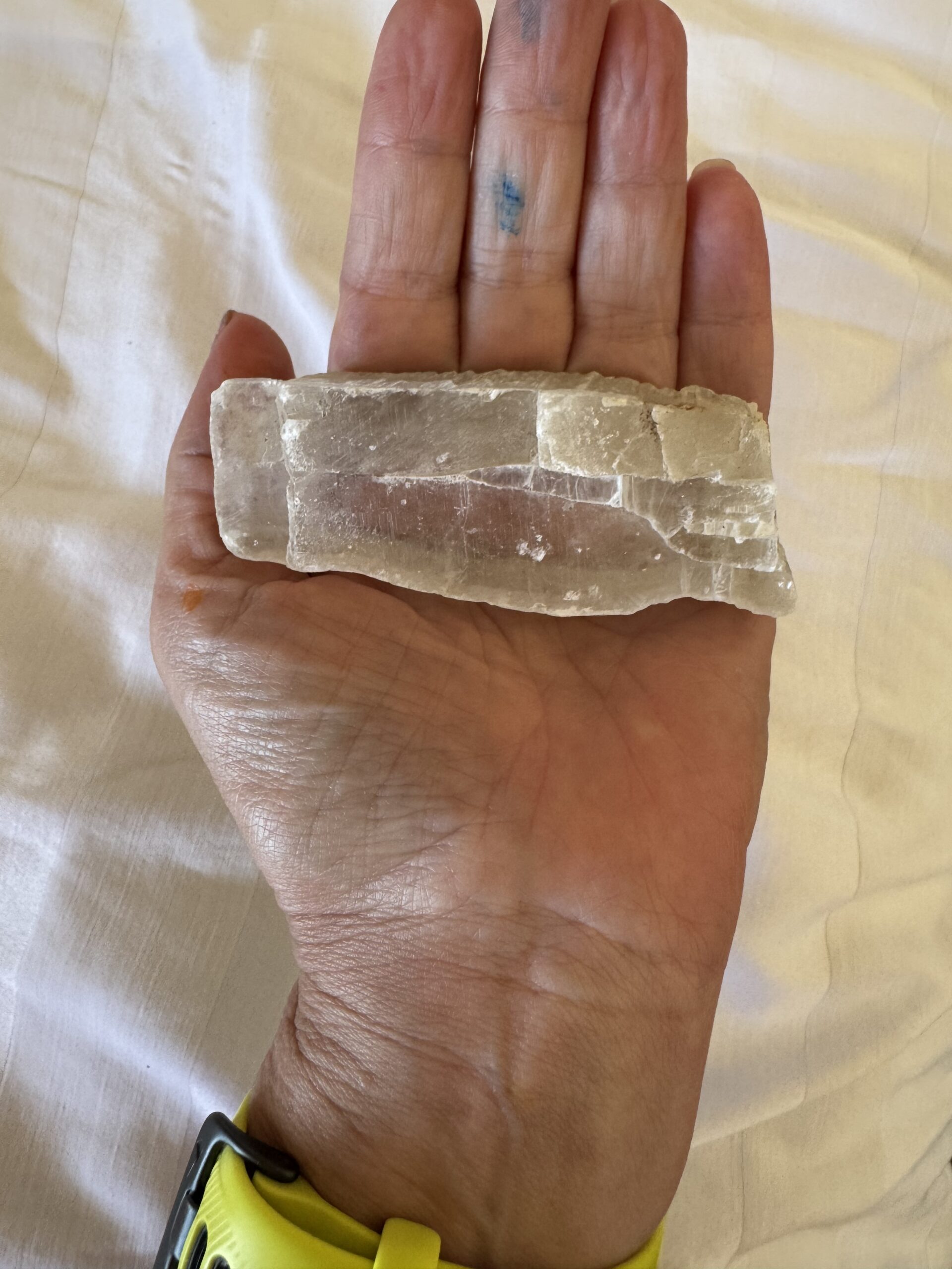 A translucent selenite crystal held in an open palm, a moment of solitary presence with stone, Loreto, Baja California Sur