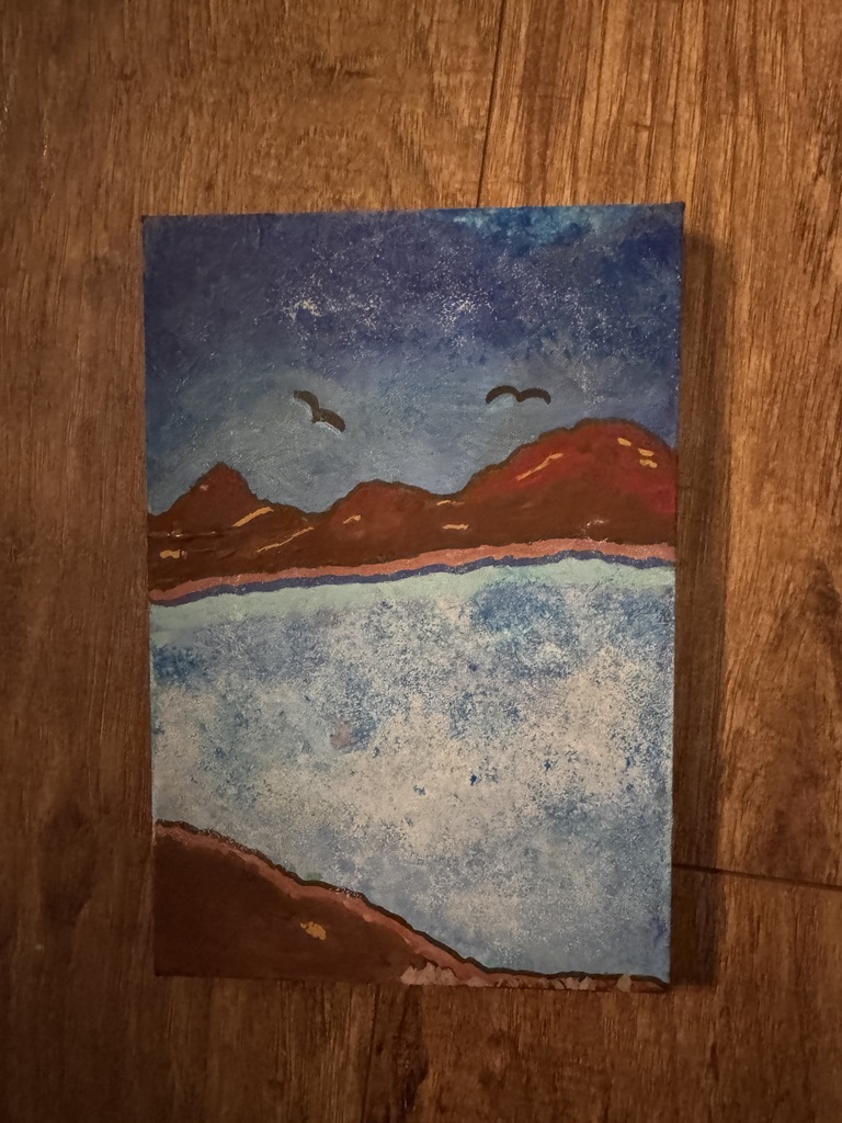 A memory painting of the Loreto Bay shoreline at nightfall, showing a deep violet and blue starlit sky with two birds in silhouette, rust-red mountains behind the waterline, and white surf breaking against a terracotta shore.